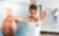 Young woman practicing basic self-defense techniques while training in gym with male partn