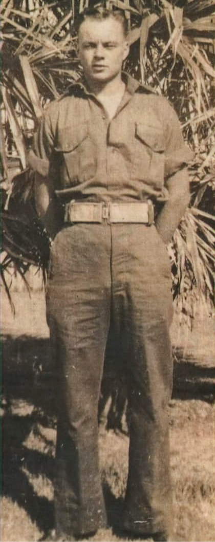 Picture of Noel Frederick South in his late teens or early twenties. Date uncertain.Standing on grass in front of a tree.