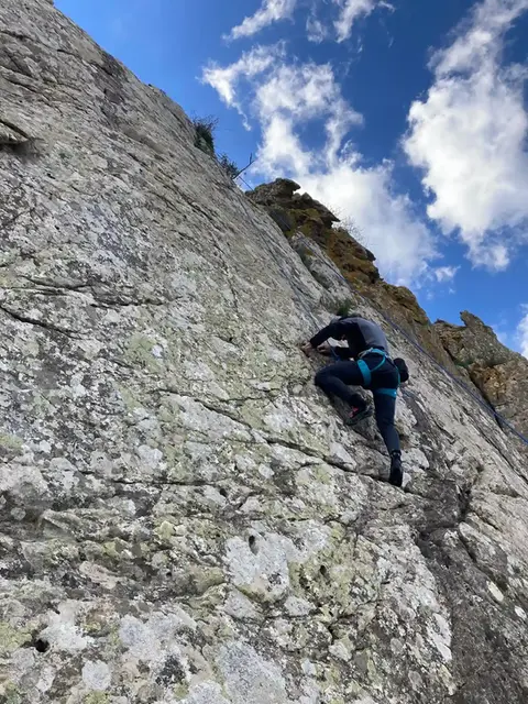 Man is climbing on a steep hill