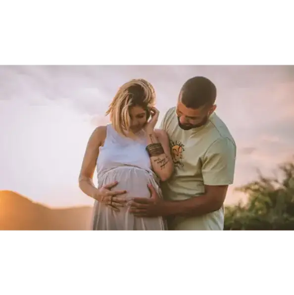 expecting couple smiling for their maternity photoshoot and their upcoming birth supported by a doula in atlanta
