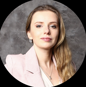 Portrait photo of a woman with a subtle smile wearing pink blazer