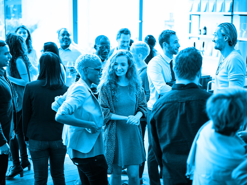 Diverse group of AEC professionals networking at an industry event