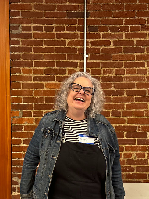 Happy Kirsten Ervin by brick wall