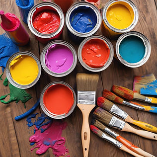 pails of brightly colored paint surrounded by used paintbrushes and drop cloth.jpg
