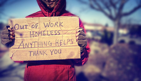 a homeless person with a sign.jpg