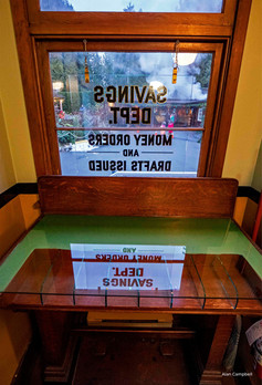 Savings and Loan Window reflecting off glass table top