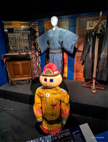 Display with short robot fire person in front and mannequin in back wearing Japanese yukata