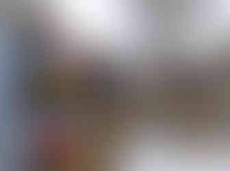 Photo of display wall at Rancho Deluxe painted with brightly colored rectangles, with bicycles and bicycle tires hanging in front.