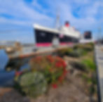 Old, rusted, 1970s Soviet submarine docked in front of the Queen Mary.