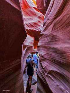 People walking through narrow space in Lower Antelope Canyon