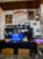 Display area with posters, photos, police hats and small television.