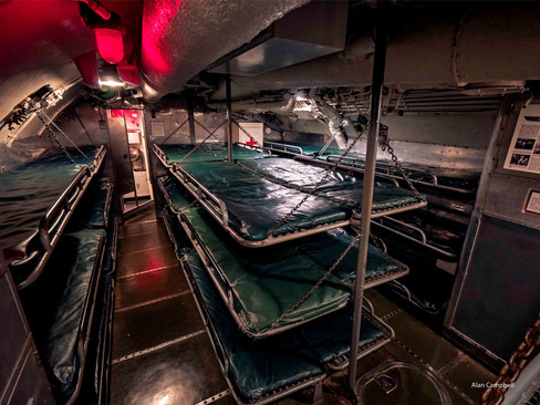 Sleeping room on the Silversides show cots, stacked closely together, three high.
