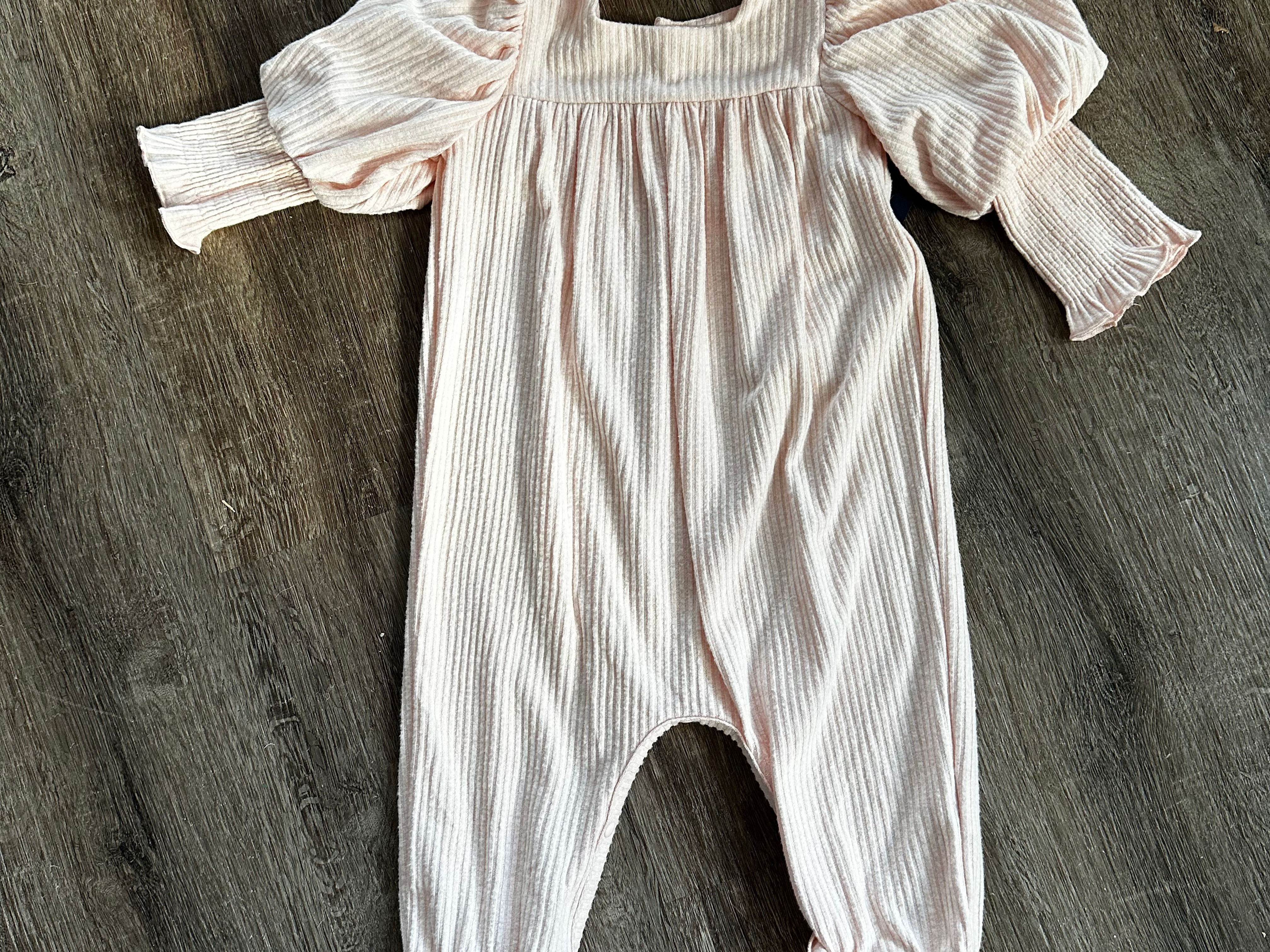Pink romper with smocked sleeve detail