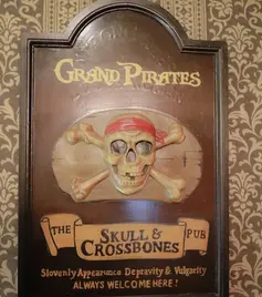 Grand Pirates wall decoration featuring a skull and crossbones sign with a classic pirate pub design.