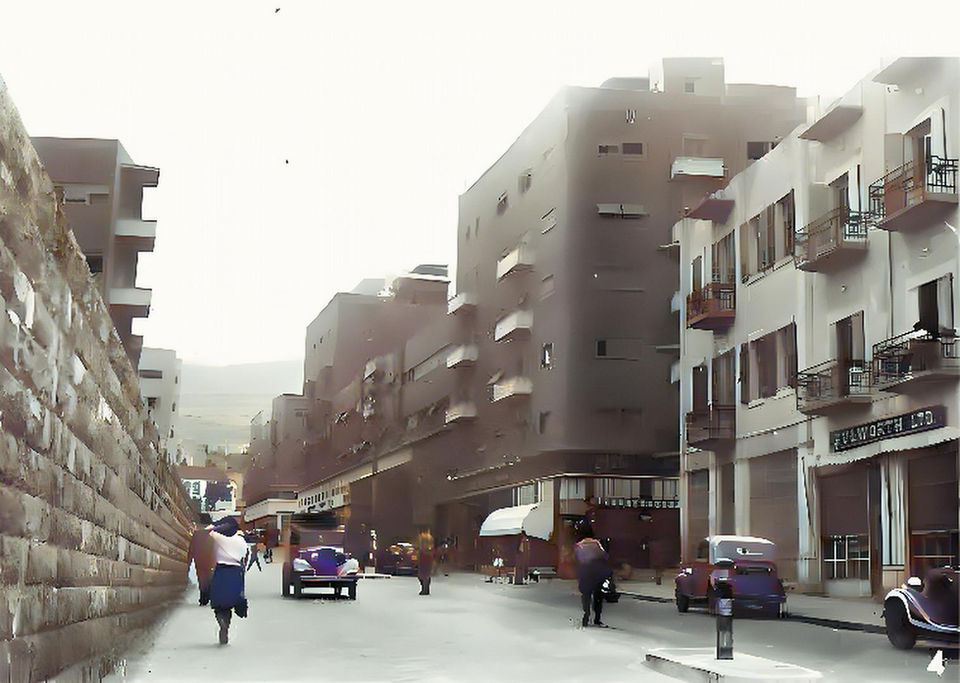 Vintage street scene: 1930s Tel Aviv architecture, pedestrians, and cars
