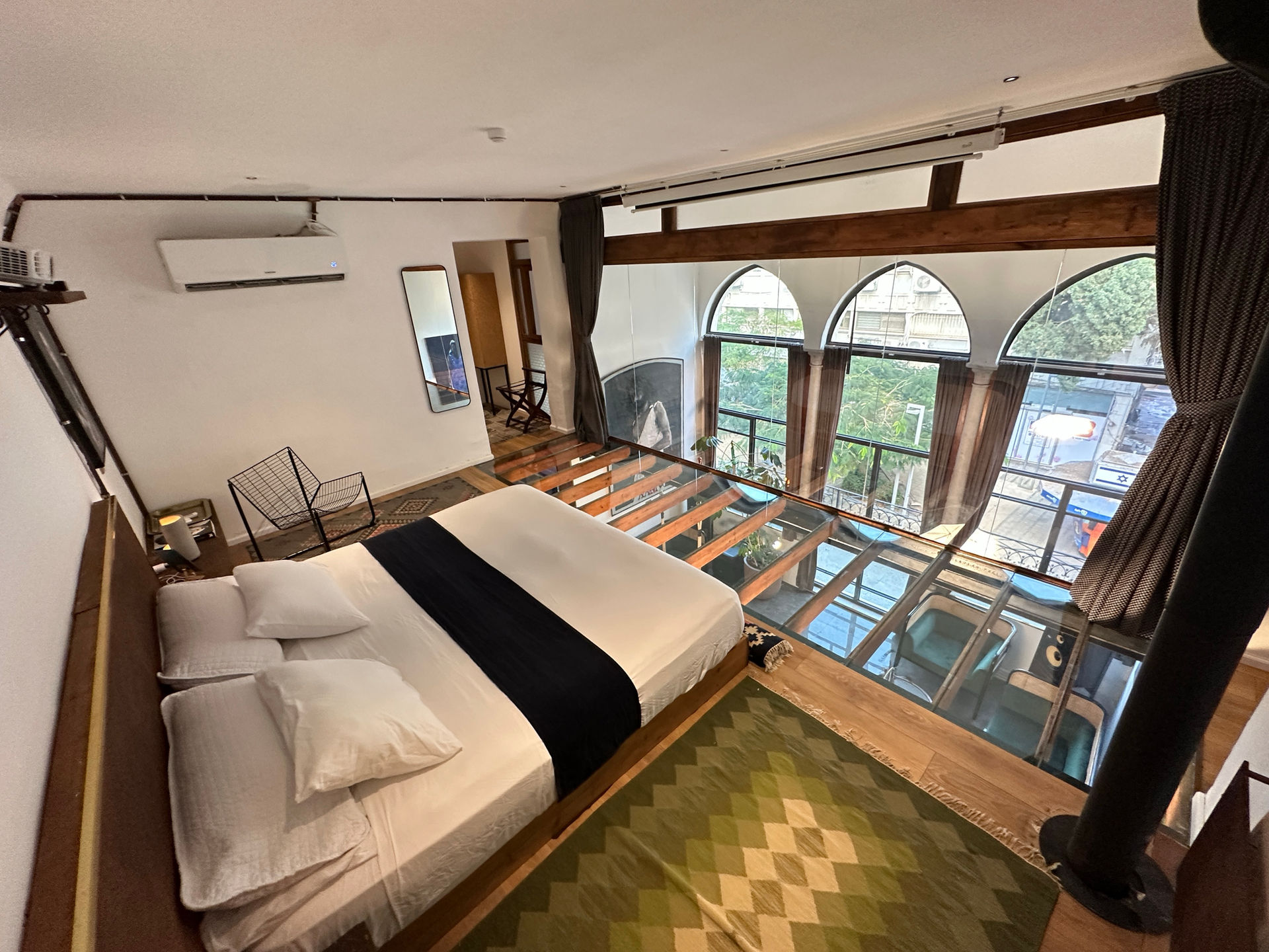 Spacious bedroom with glass floor overlooking garden