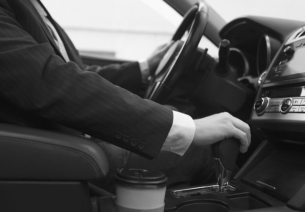 man-using-his-car-s-options-while-drivin