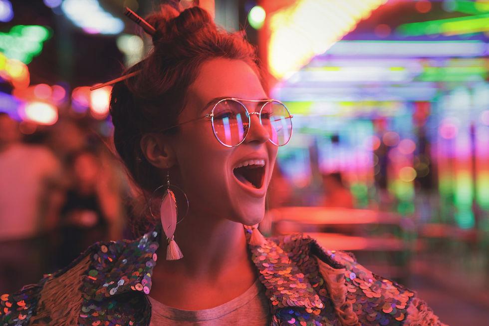 A young woman, surrounded by bright lights cheering.