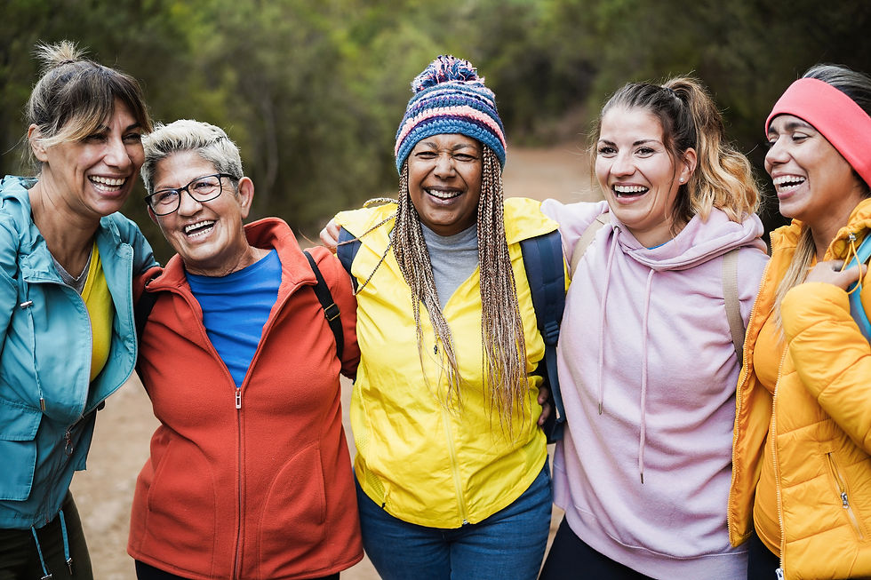 Three women side-by-side smiling.