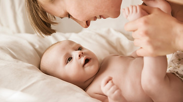 Mother Smiling With Newborn Baby