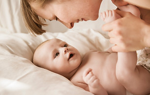 Mother Smiling With Newborn Baby