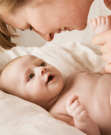 Mother Smiling With Newborn Baby