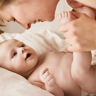 Mother Smiling With Newborn Baby