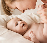 Mother Smiling With Newborn Baby