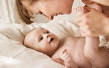 Mother Smiling With Newborn Baby