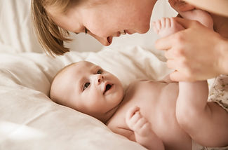 Mother Smiling With Newborn Baby