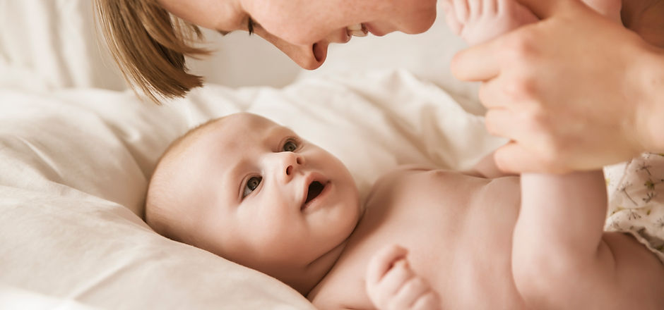 Mother Smiling With Newborn Baby