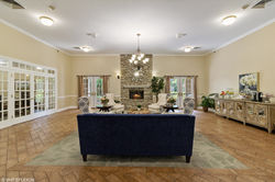 Welcoming community lounge with comfortable seating and chandeliers at a Generation Healthcare Manag