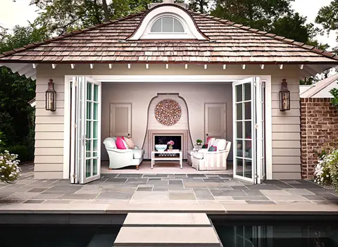 Cozy outdoor pavilion with a stylish fireplace surround, adorned with welcoming seating and vibrant cushions.