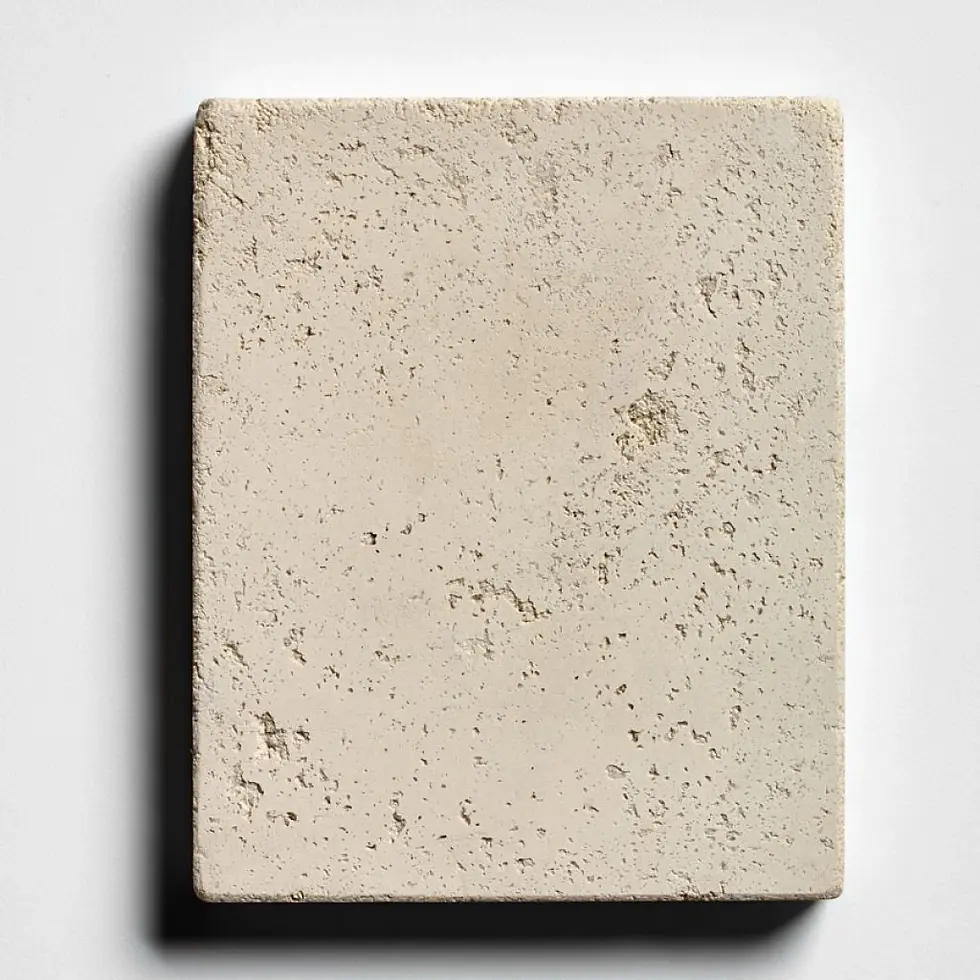 Cast stone fireplace surround sample in a medium buff color and a distressed finish mimicking natural travertine.