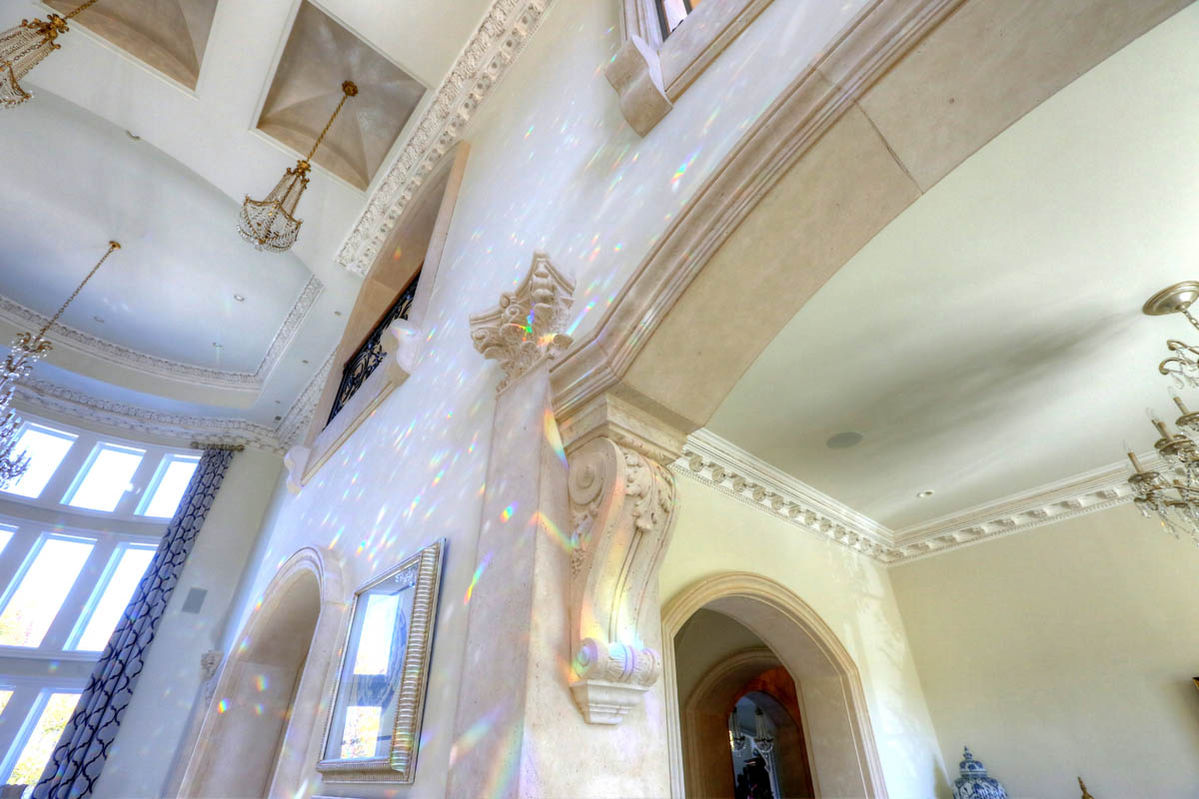 Interior space featuring a set of custom cast stone columns with ornate corbels and classic arch designs.