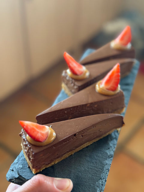 Multiple chocolate cheesecakes on a slate served at a catering event in Kent, UK