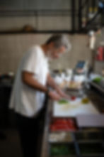 Eyal Shani at Miznon Tel Aviv chopping spicy green peppers.