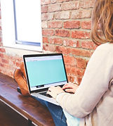 white female lounging with laptop depicting the ease of online counseling with mckenziecounseling.org
