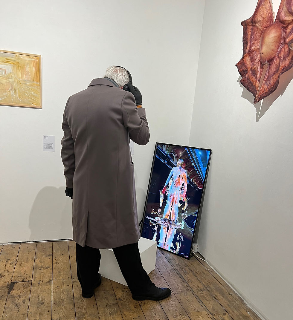 A visitor with a digital work at Bermondsey Project Space, 2023. Photo by Kate Fensterstock.