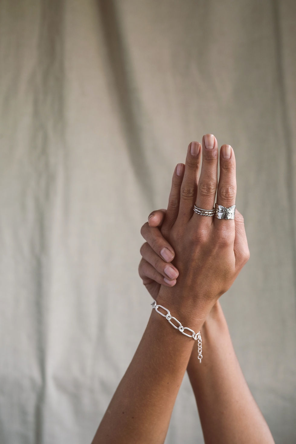 Thumbnail: close up of hands wearing silver organic wide ring