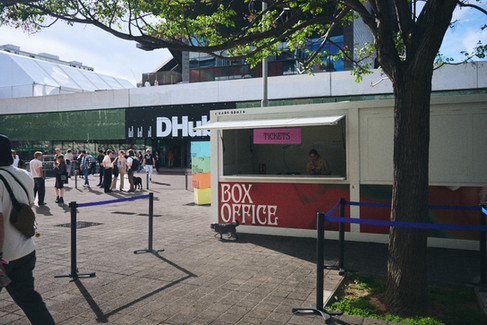 box office ticket booth at OFFF Barcelona with visitors arriving, event focused on CGI, 3D, design and visual culture