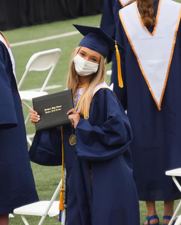 Graduation from high school in 2021: outside, wearing masks, and only allowed four guests.