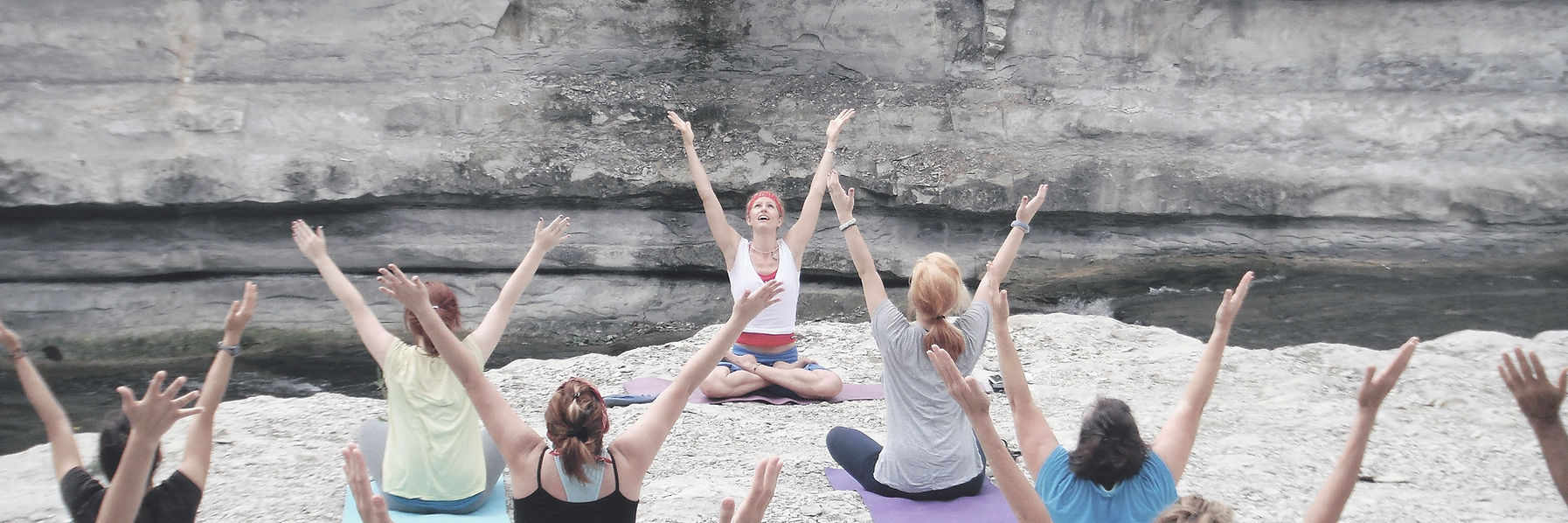 Group Yoga Session outdoors on cliffside