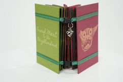 Open book shows "Freak Meat to the Neighborhood" and illustrations on the covers.