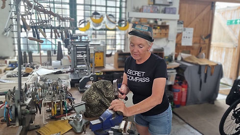 Woman working on mechanical parts in a workshop