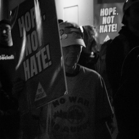 A man walking with the crowd as the protestors returned to the original meeting location. He carries a sign from the WA Greens party, reading; "Hope Not Hate!", Pauline Protest Midland, June 2026, River Higgs