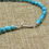 Thumbnail: Small Polished Nugget Turquoise Gold Colored Bead Accent Necklace