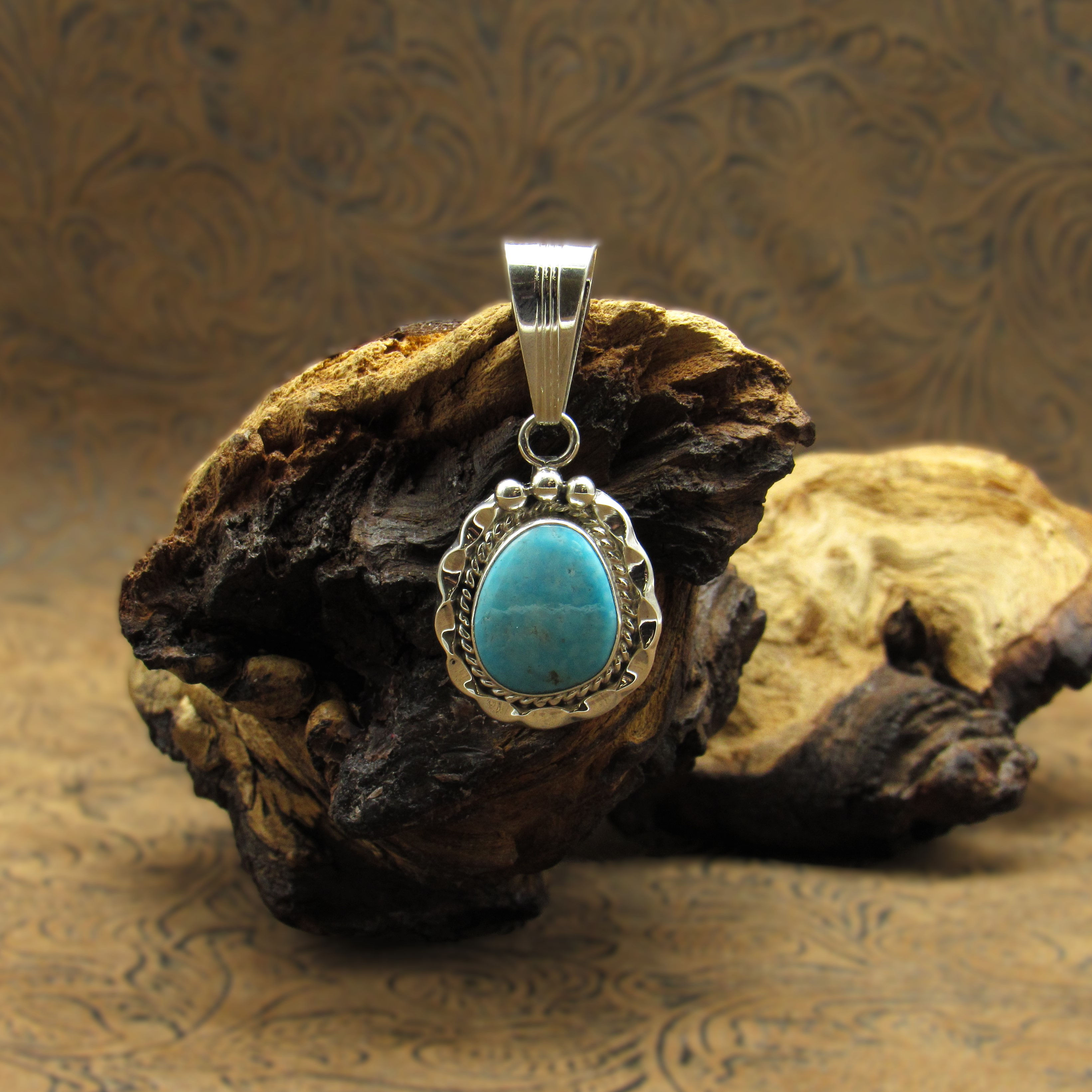 Sterling Silver Pendant With Turquoise Stone And Ribbon Design