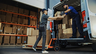 Outside of Logistics Distributions Warehouse_ Diverse Team of Workers use Hand Truck Loadi