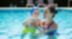 boy blowing bubbles in pool